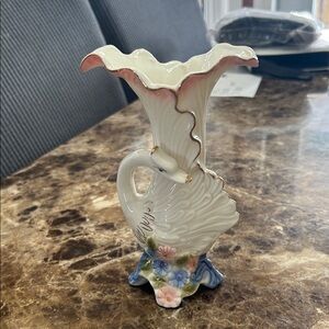 A vintage Hull Pottery "Blossom Flite" swan vase with floral accents.